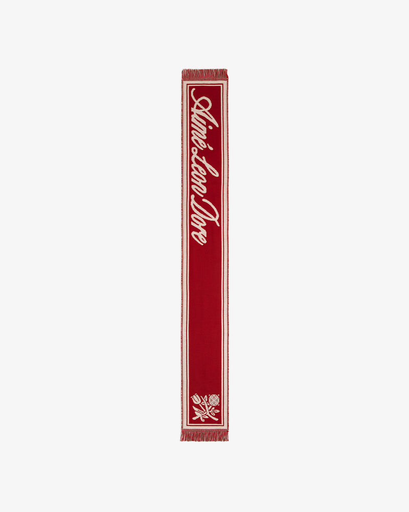 Red Wool Script Scarf featuring white script text and a floral graphic at the bottom.