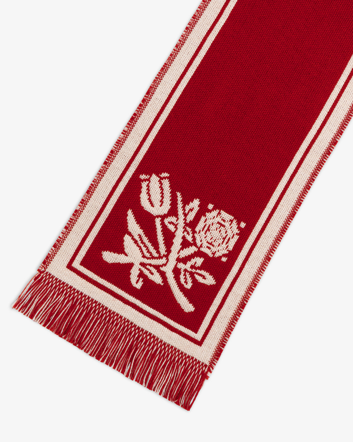 Wool Script Scarf in red with a white border, floral pattern, and fringed edges.