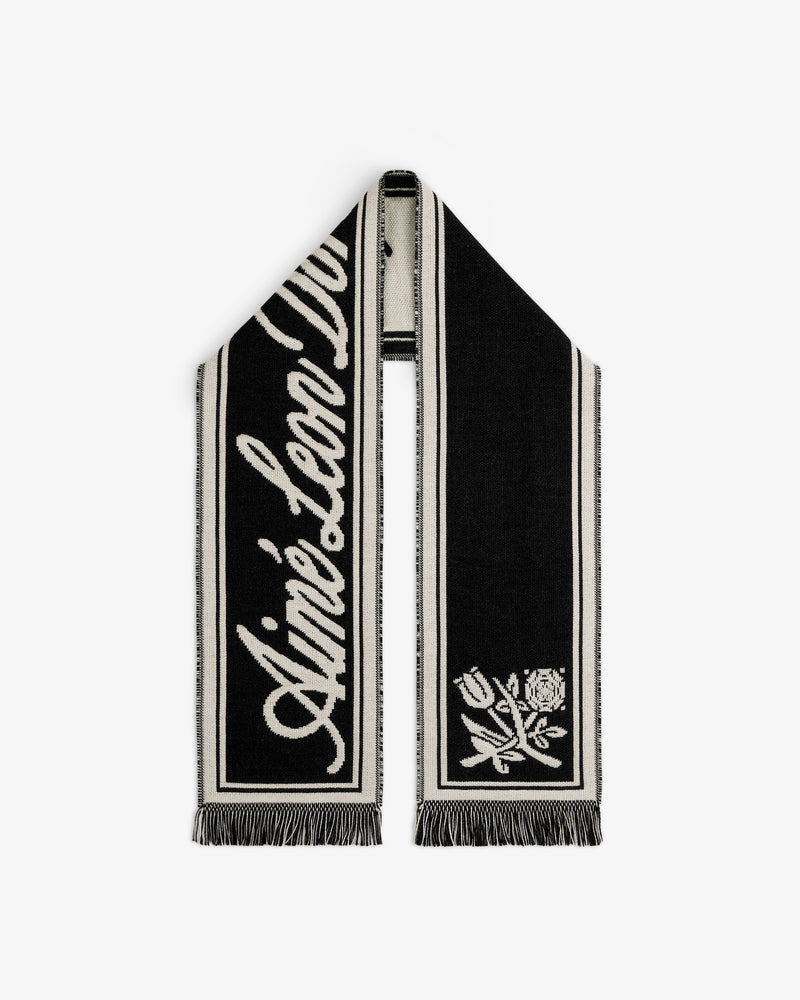 Wool Script Scarf in black and cream knit with cursive text and a floral graphic on the ends.