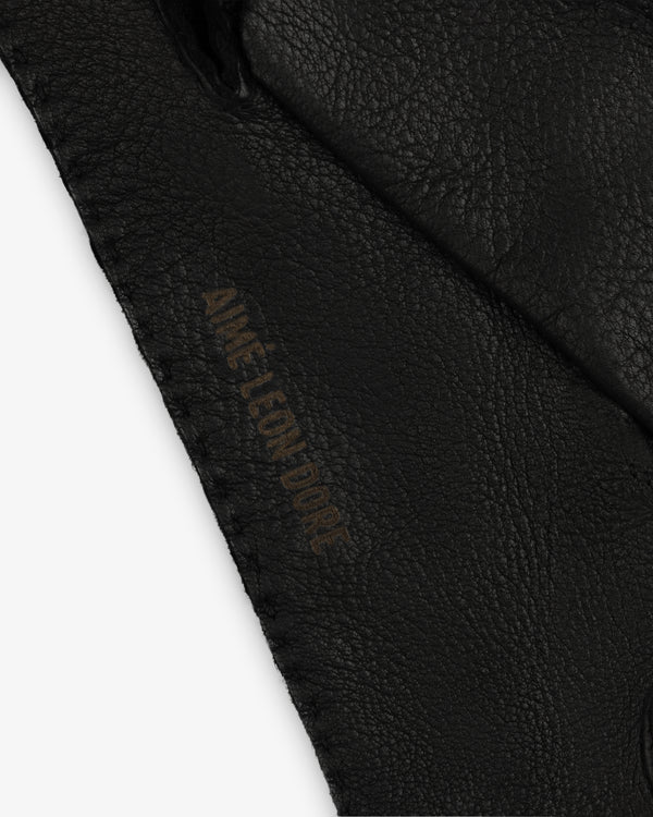 Black Henry Gloves in leather featuring the embossed text Aime Leon Dore.
