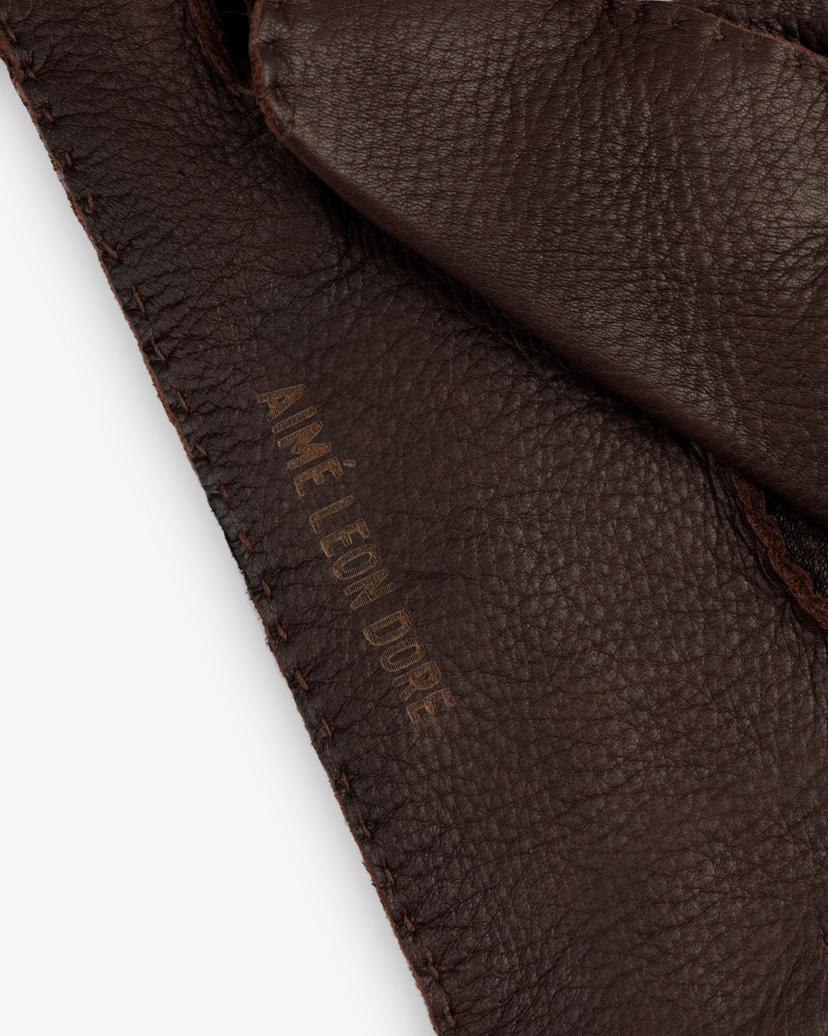 Henry Gloves in dark brown leather with an embossed logo on the cuff.
