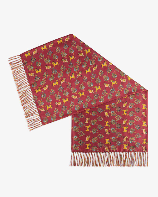 Archival Print Silk Fringe Scarf in red with a yellow animal pattern, floral motifs, and fringed ends.