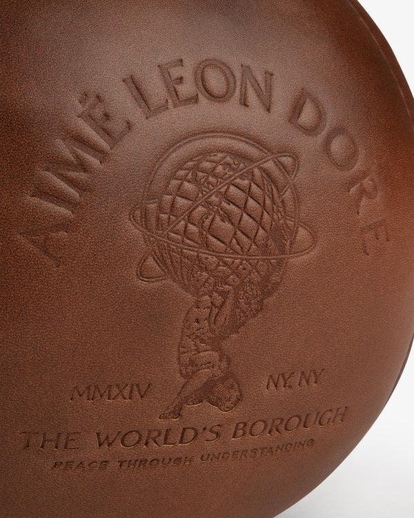 Atlas Vintage Leather 10 Lb Kettle Bell: brown leather, embossed with a globe logo, Aime Leon Dore, MMXIV NY NY, and Queens.
