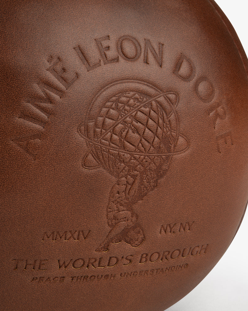 Atlas Vintage Leather 10 Lb Kettle Bell: brown leather, embossed with a globe logo, Aime Leon Dore, MMXIV NY NY, and Queens.