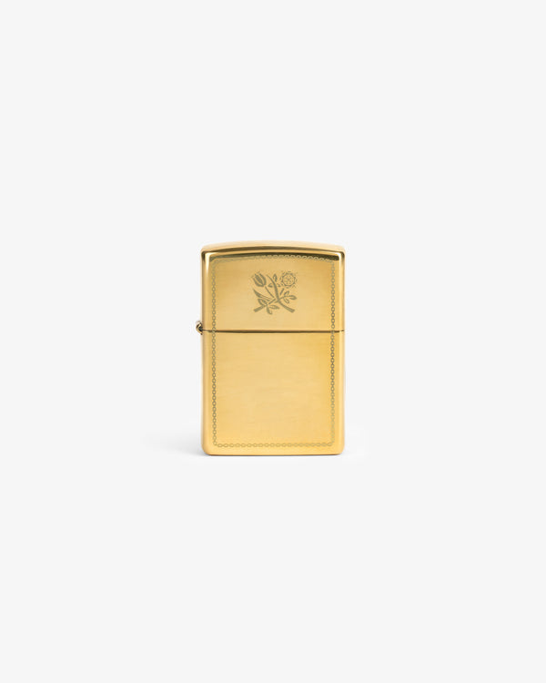 Graphic Zippo Lighter with a small floral engraving on the front, displayed against a plain white background.