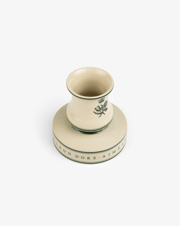 Porcelain Match Striker with green floral design and text on base, displayed on a white background.
