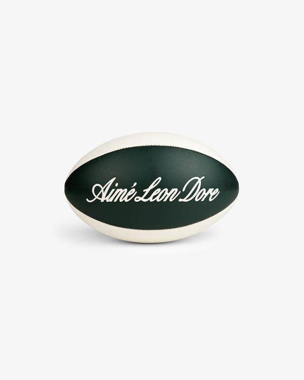 The Script Rugby Ball is green and white with “Aimé Leon Dore” in cursive on the front.