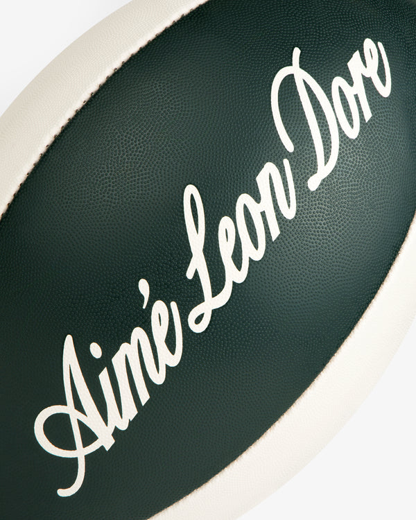 Script Rugby Ball: A dark green ball with white Aimé Leon Dore script and a white edge stripe.