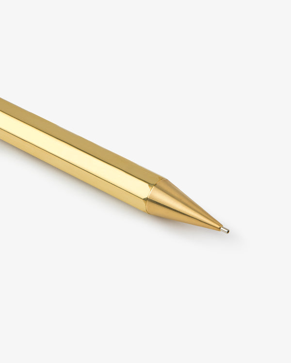 A close-up of a Kaweco Script Mechanical Pencil’s shiny gold tip on a white background.