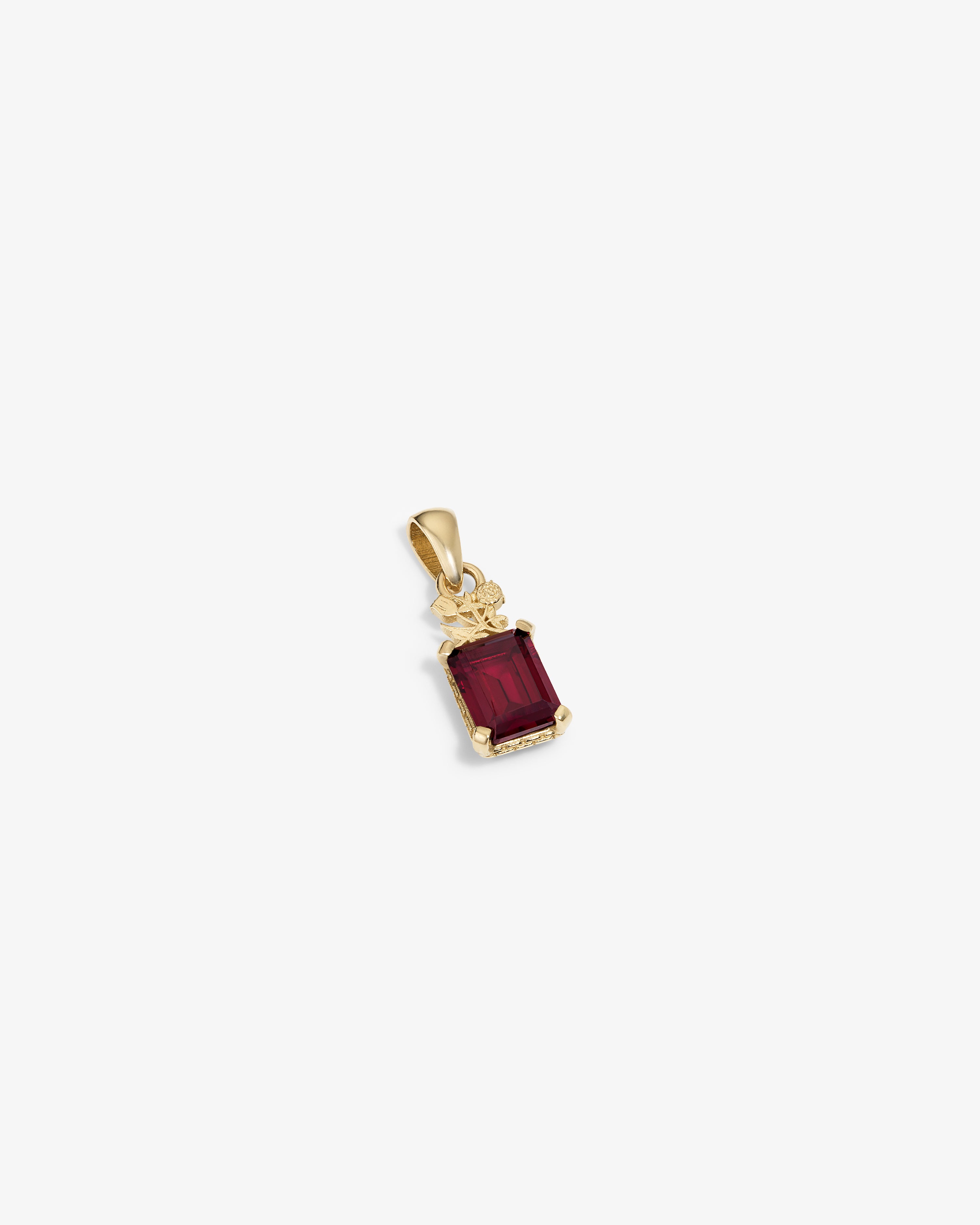 14Kt Gold Crest Gemstone Pendant featuring a rectangular red stone with decorative accents on a white background.