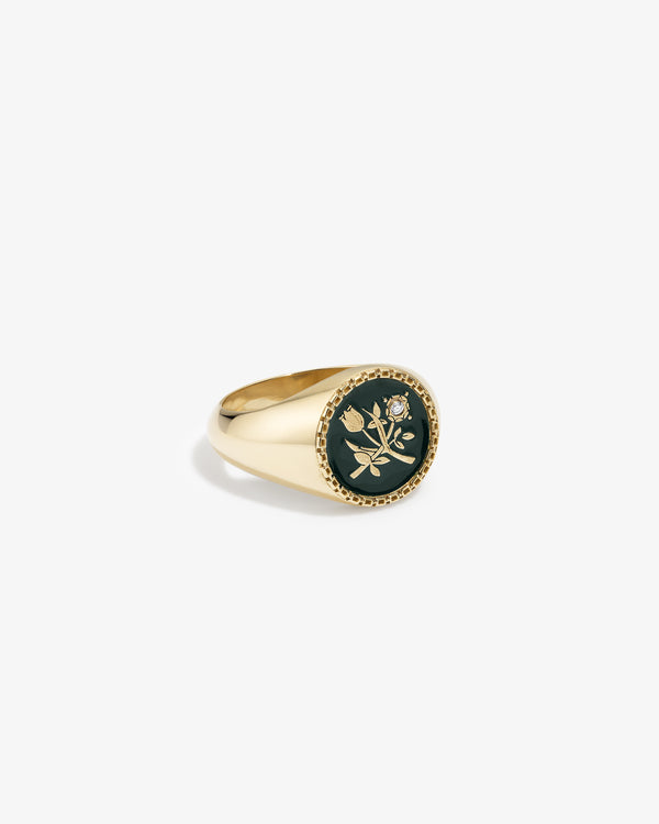 14Kt Gold Stained Glass Crest Ring: a gold signet ring with a round black inlay, gold floral design, and small diamond.