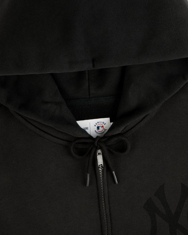 Close-up of a Yankees Washed Full-Zip Hoodie in black, featuring a drawstring and a visible inside collar tag.
