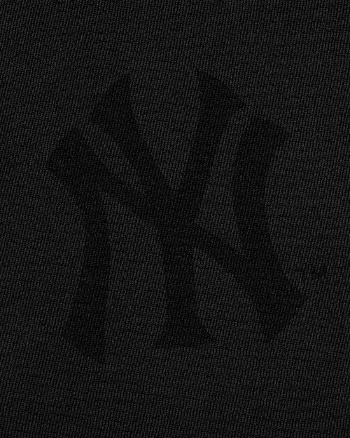 Yankees Washed Full-Zip Hoodie with a black logo subtly blending into the dark textured background.
