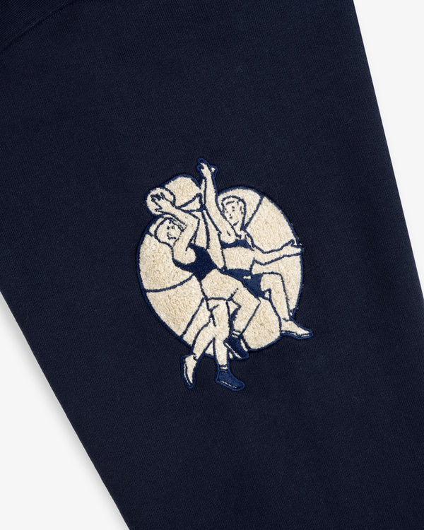 Mulberry Letterman Hoodie: features an embroidered basketball scene on dark blue fabric with a circular backdrop.