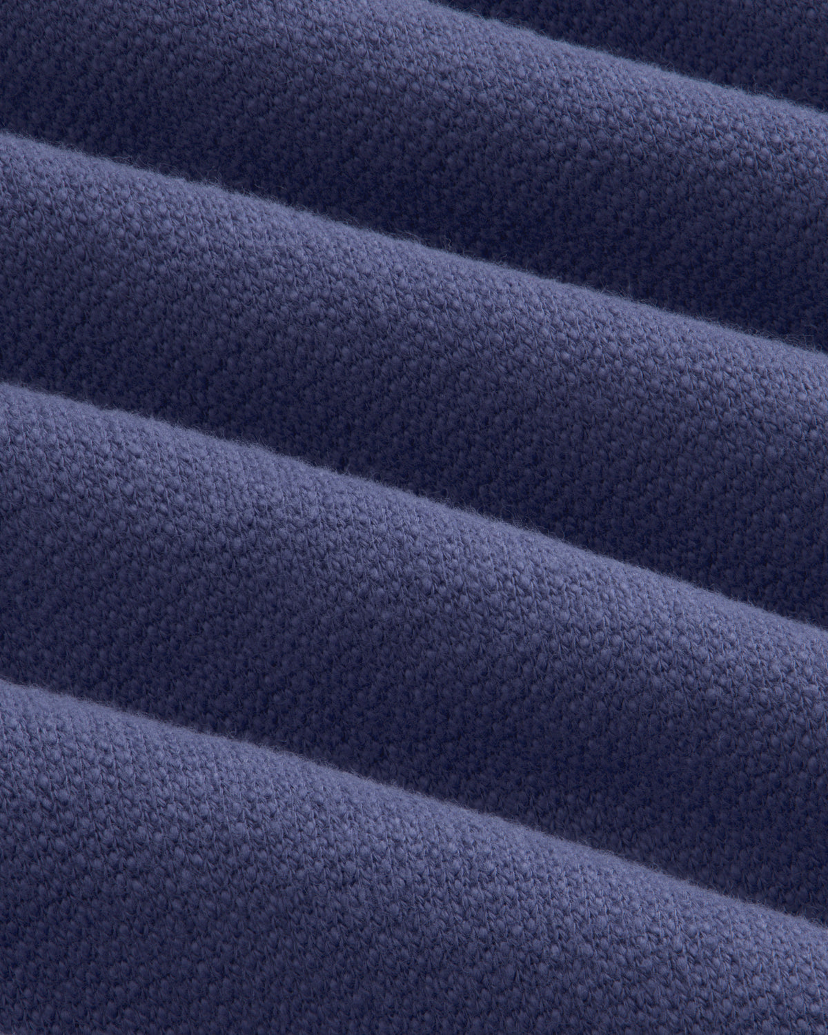 Close-up of Stone Washed Marina Hoodie fabric, highlighting its ribbed, textured blue surface with diagonal lines.