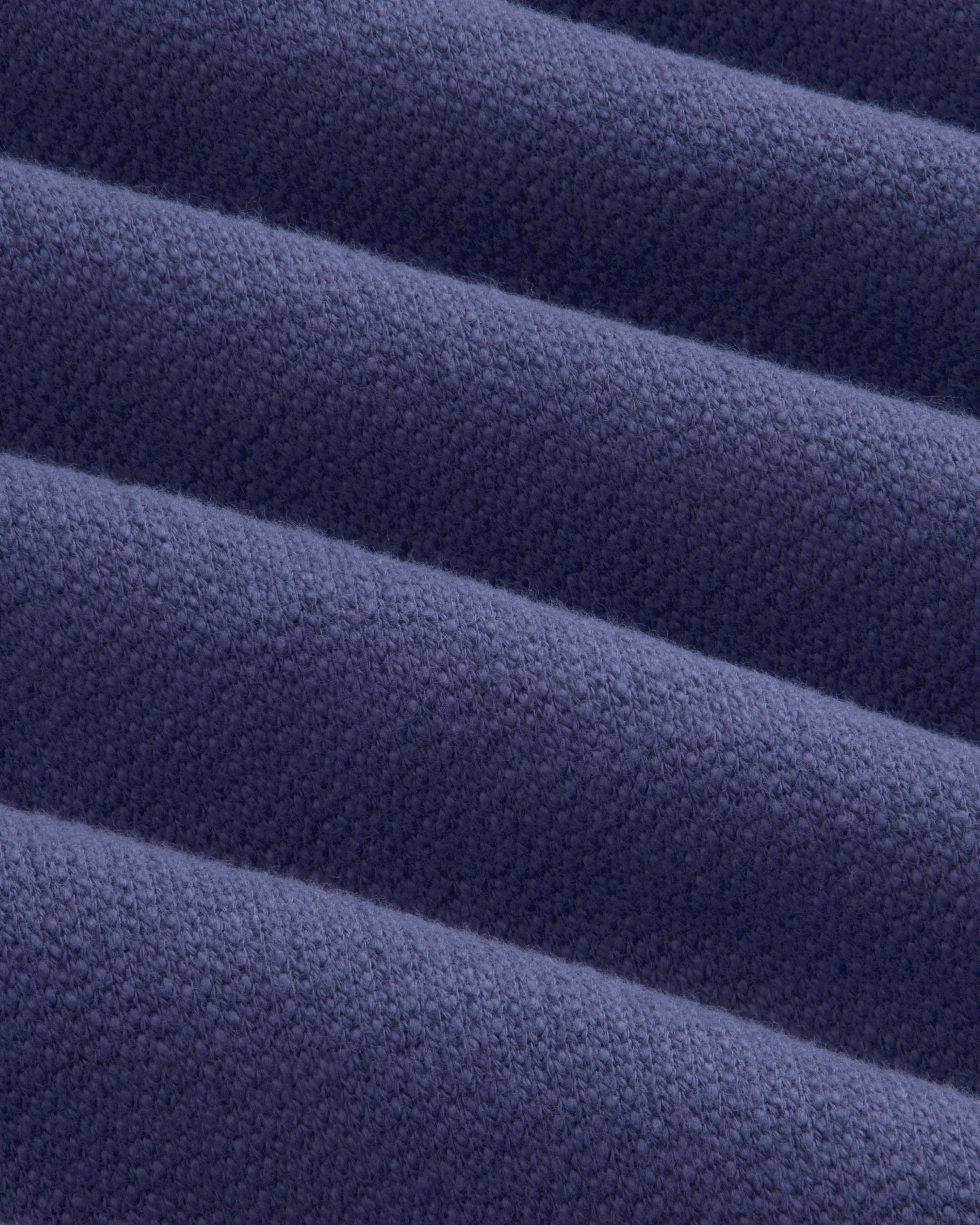 Close-up of Stone Washed Marina Hoodie fabric, highlighting its ribbed, textured blue surface with diagonal lines.