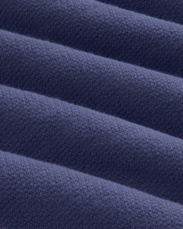 Close-up of Stone Washed Marina Hoodie fabric, highlighting its ribbed, textured blue surface with diagonal lines.