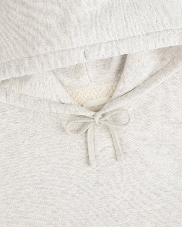Close-up of the Stone Washed Marina Hoodie, featuring a bow-tied drawstring beneath the light gray hood.