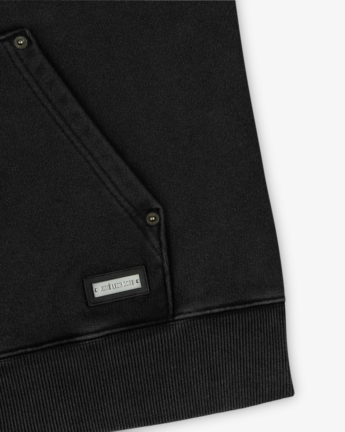 Black Washed Full Zip Hoodie with a front kangaroo pocket, metal snap buttons, and a small rectangular brand plaque.