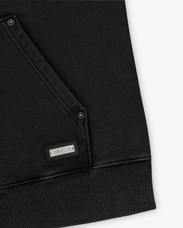 Black Washed Full Zip Hoodie with a front kangaroo pocket, metal snap buttons, and a small rectangular brand plaque.