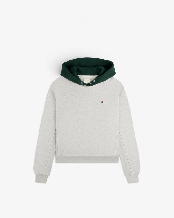 Colorblock Crest Snap Hoodie in light grey with a dark green hood and a small floral chest emblem.