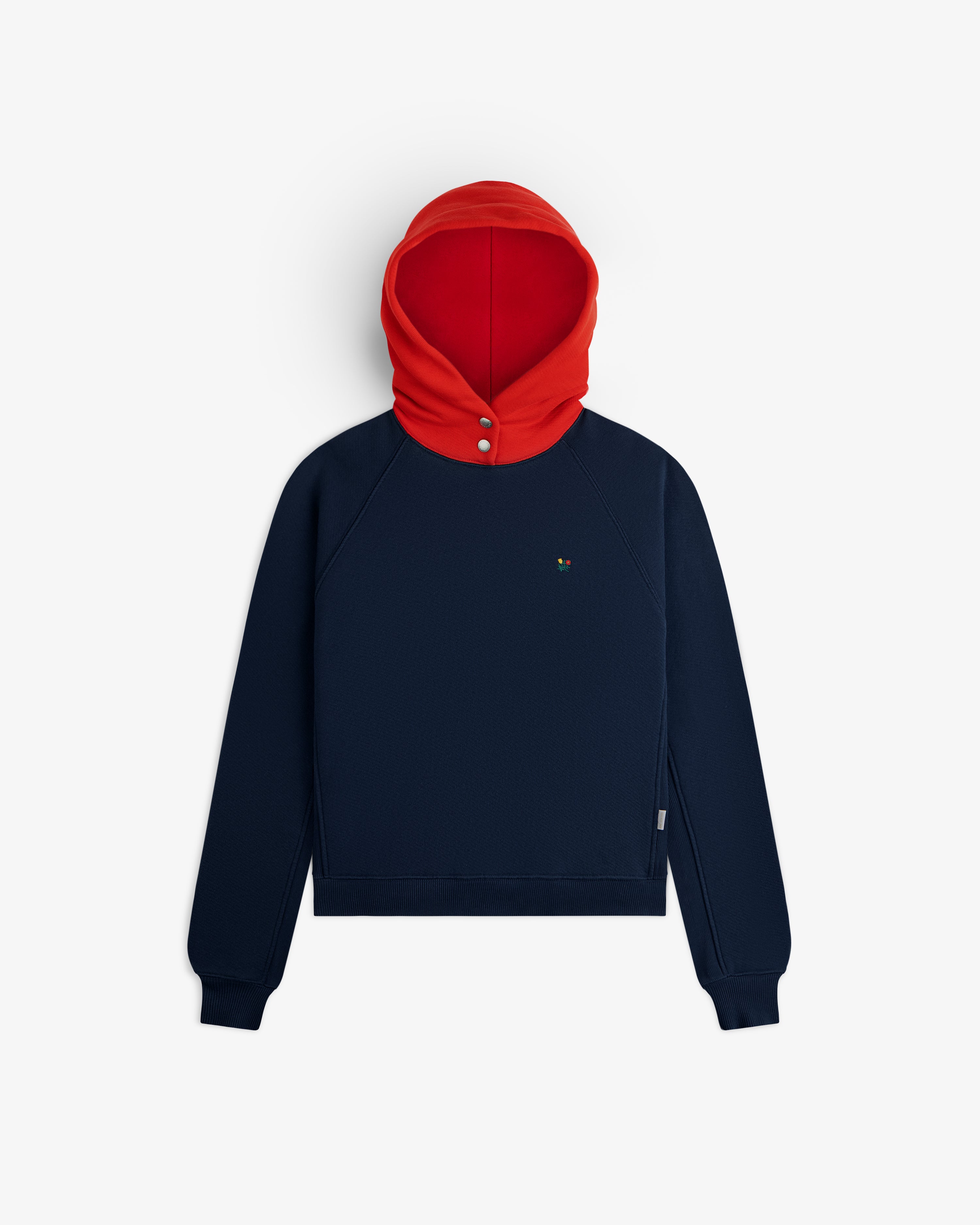 Colorblock Crest Snap Hoodie: navy blue long-sleeved pullover with a red hood and two silver snap buttons at the neck.
