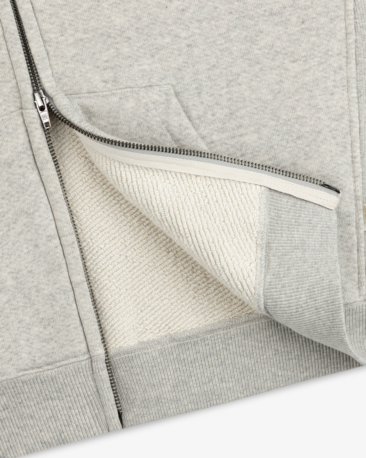 Close-up of a light gray Script Full Zip Hoodie showing the textured white interior lining.