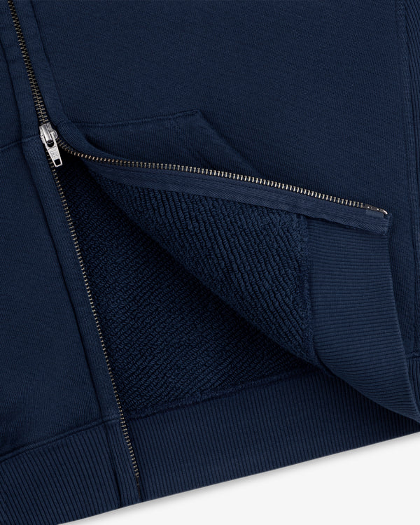 Close-up of a navy blue Script Full Zip Hoodie showing the metal zipper and the textured inner lining.