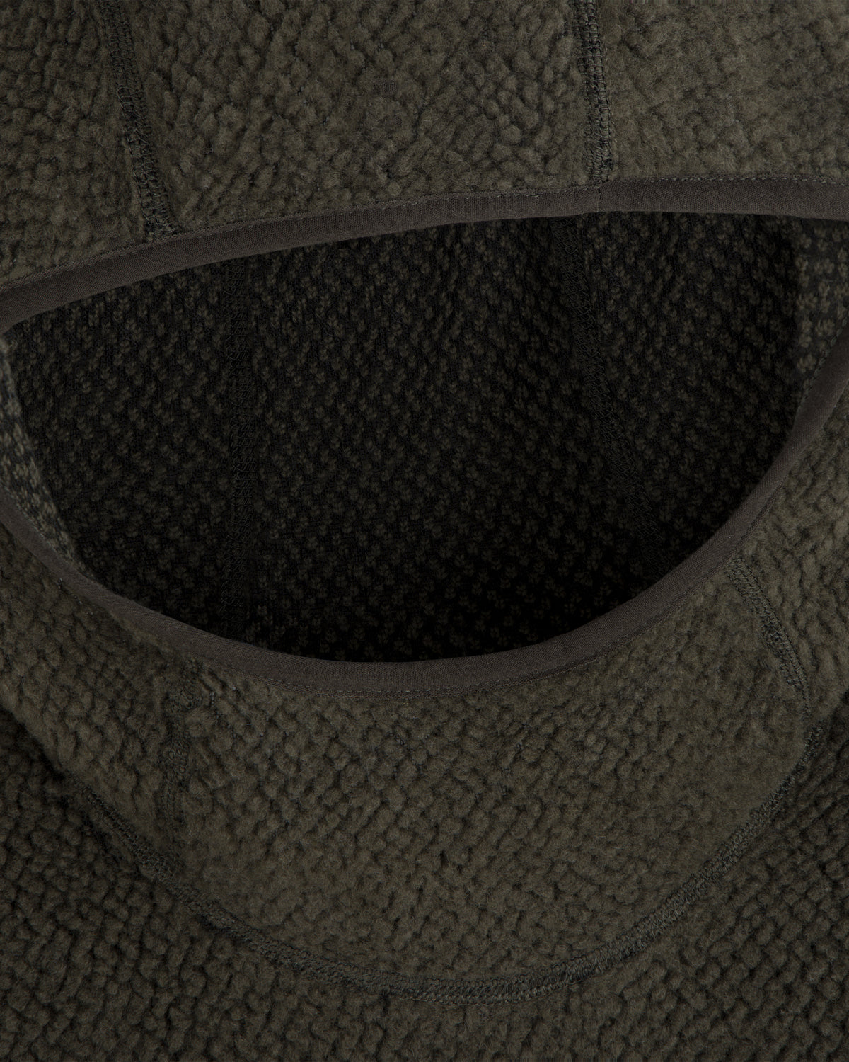 Close-up of a dark green Fleece Performance Hoodie featuring a textured, nubby finish around the hood opening.