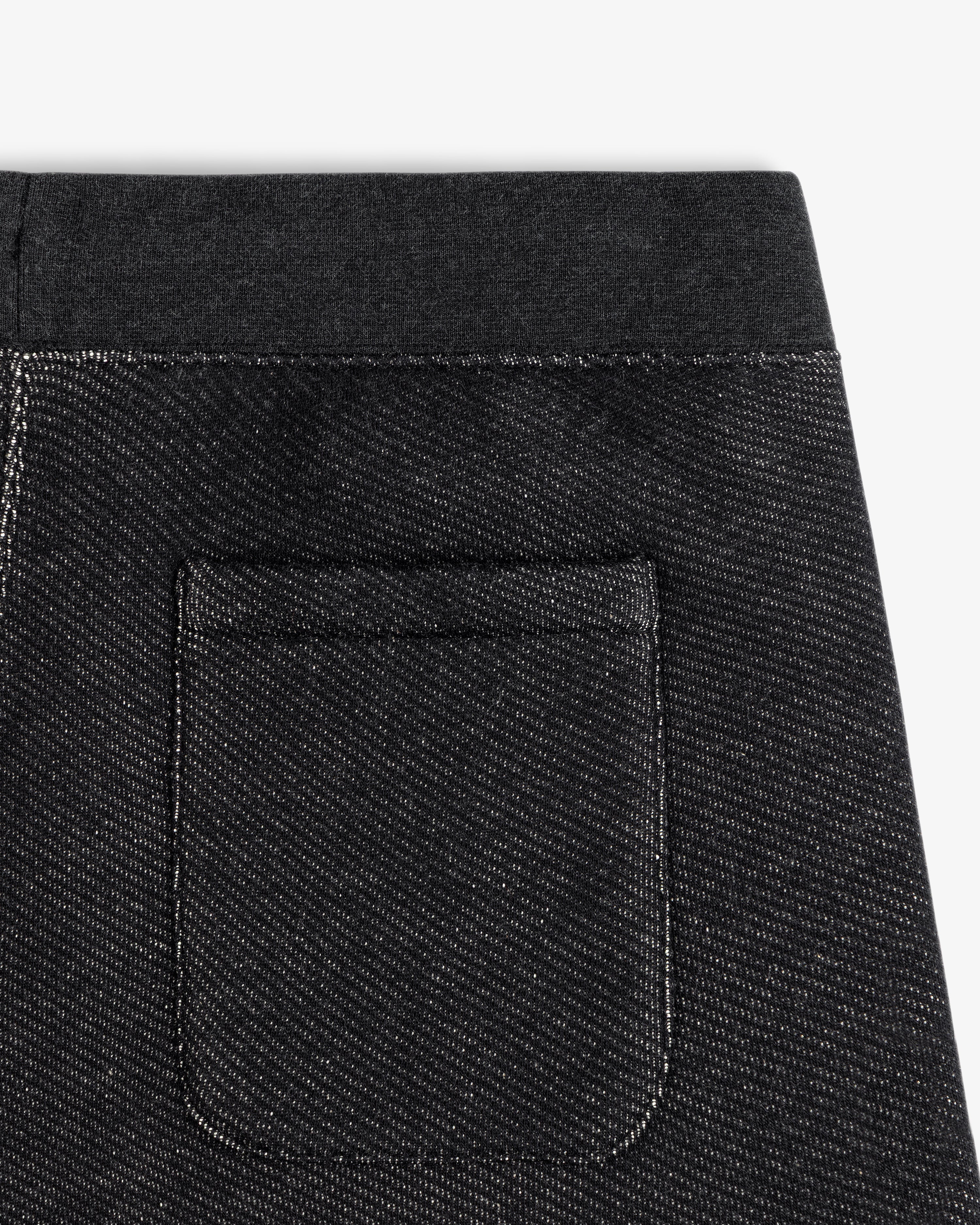 Close-up of the back pocket and waistband of dark gray Terry Lounge Sweatpant with a diagonal texture.