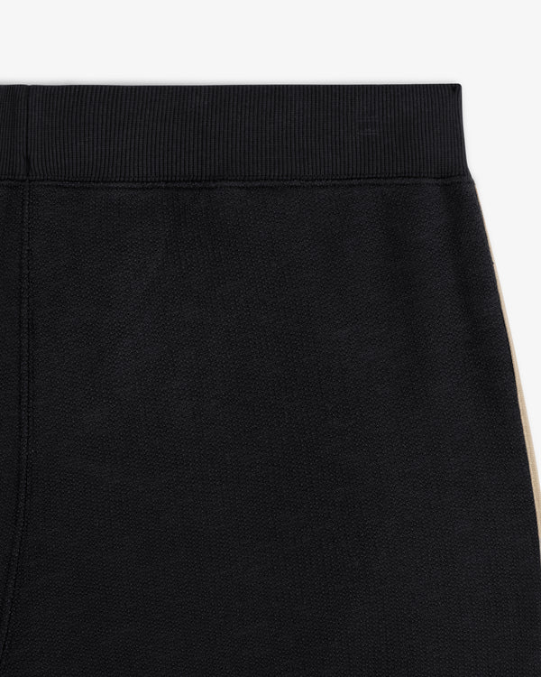 Close-up of Saint George Track Pant’s ribbed waistband and beige side stripe, highlighting the upper section.