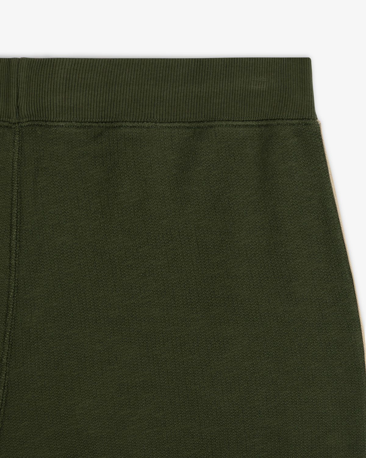 Close-up of the waistband and upper section of Saint George Track Pant in olive green against a white background.
