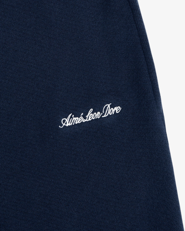 Navy Script Sweatpant featuring Aimé Leon Dore embroidered in white script.