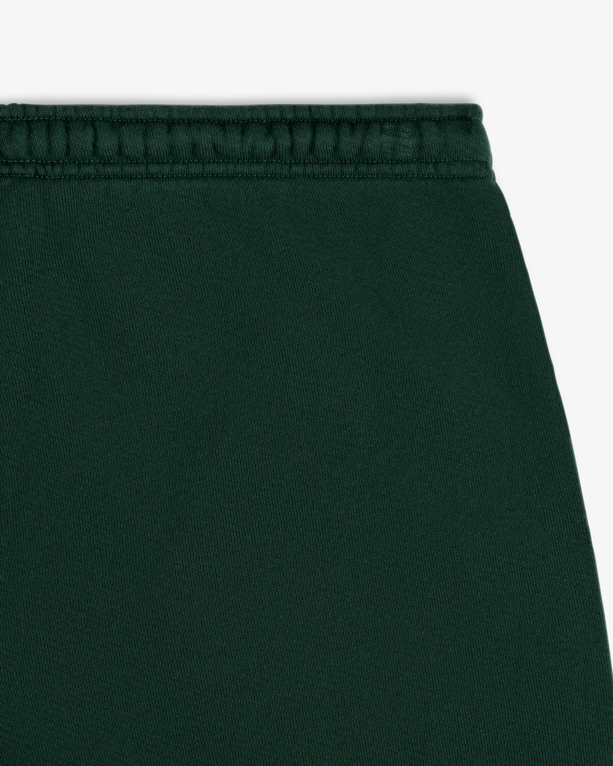 Close-up of the dark green elastic waistband of the Script Sweatpant.