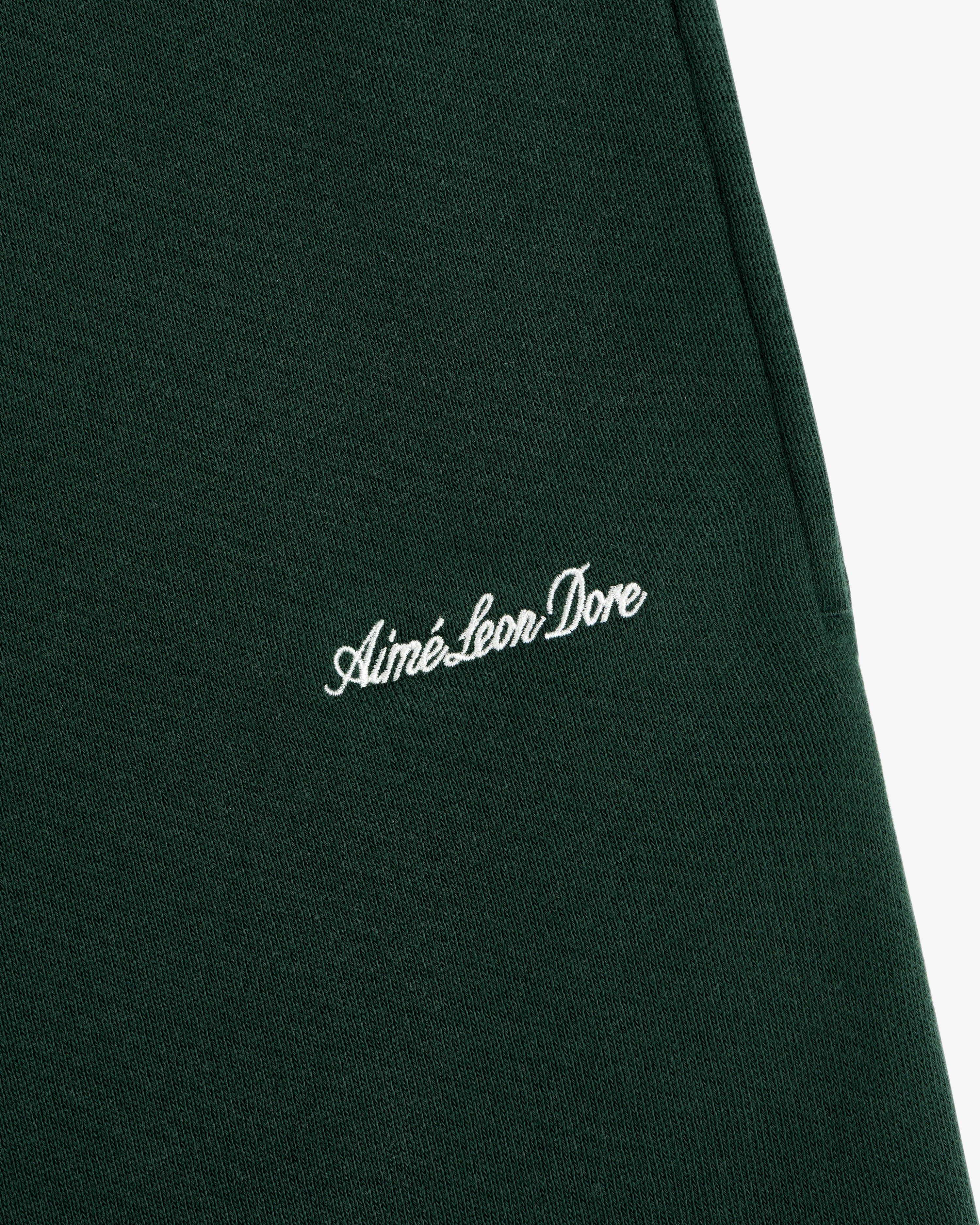 Dark green Script Sweatpant featuring white cursive script embroidery.