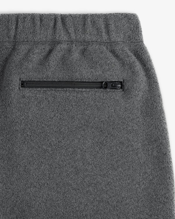 Close-up of Crest Fleece Sweatpant in gray with elastic waistband and side zippered pocket.