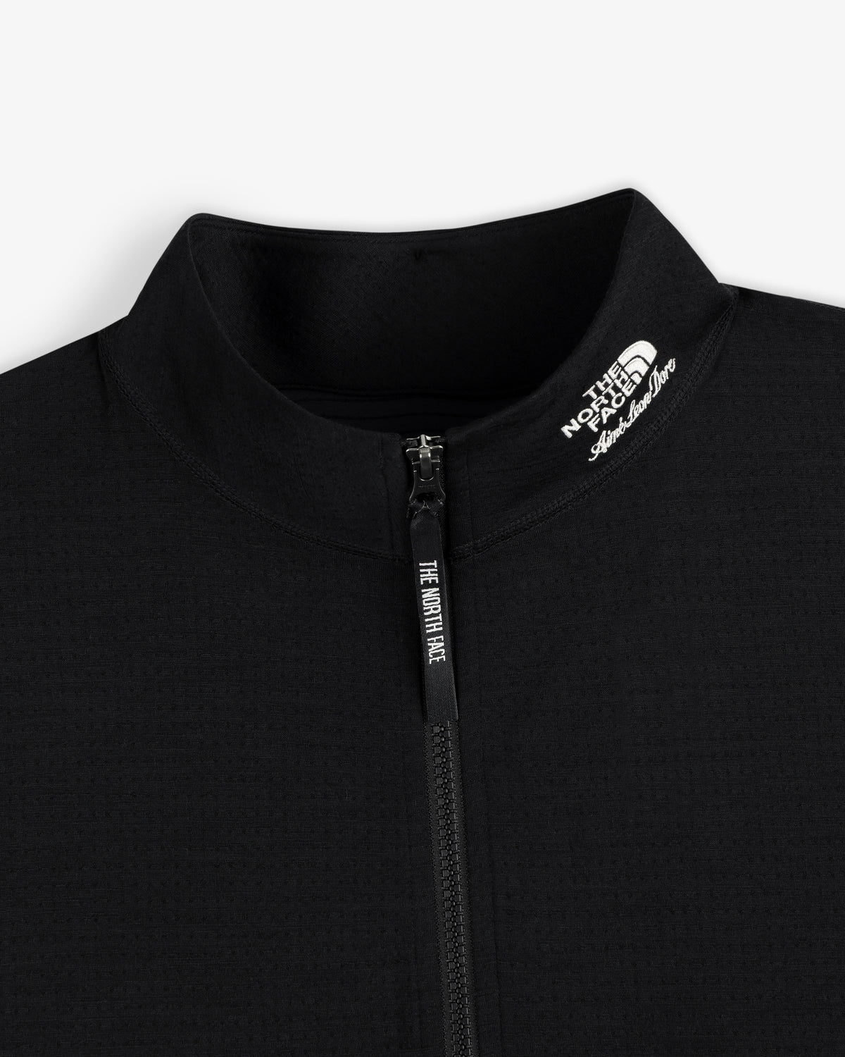 Close-up of the black ALD / The North Face DOTKNIT™ Wool Quarter Zip with zipper and white logo on the collar.