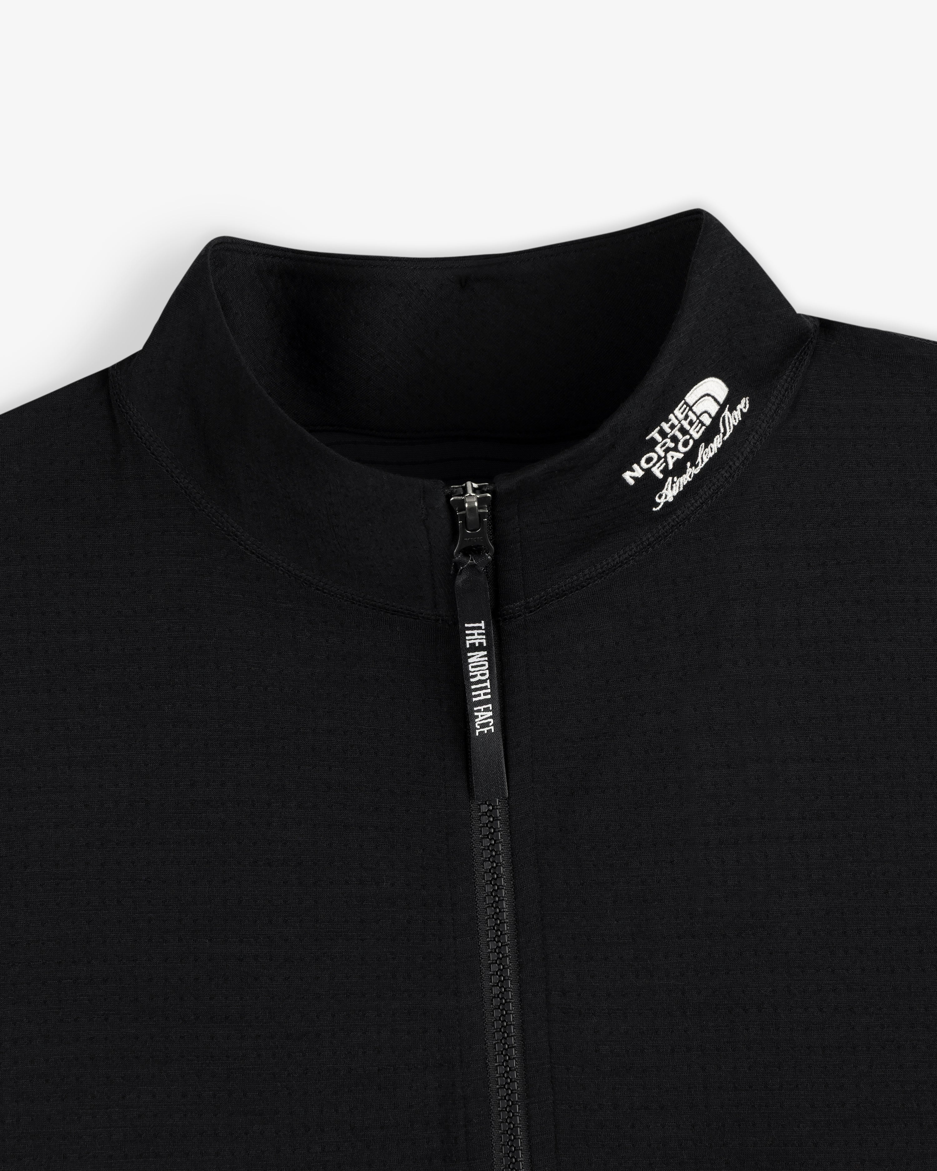 Close-up of the black ALD / The North Face DOTKNIT™ Wool Quarter Zip with zipper and white logo on the collar.