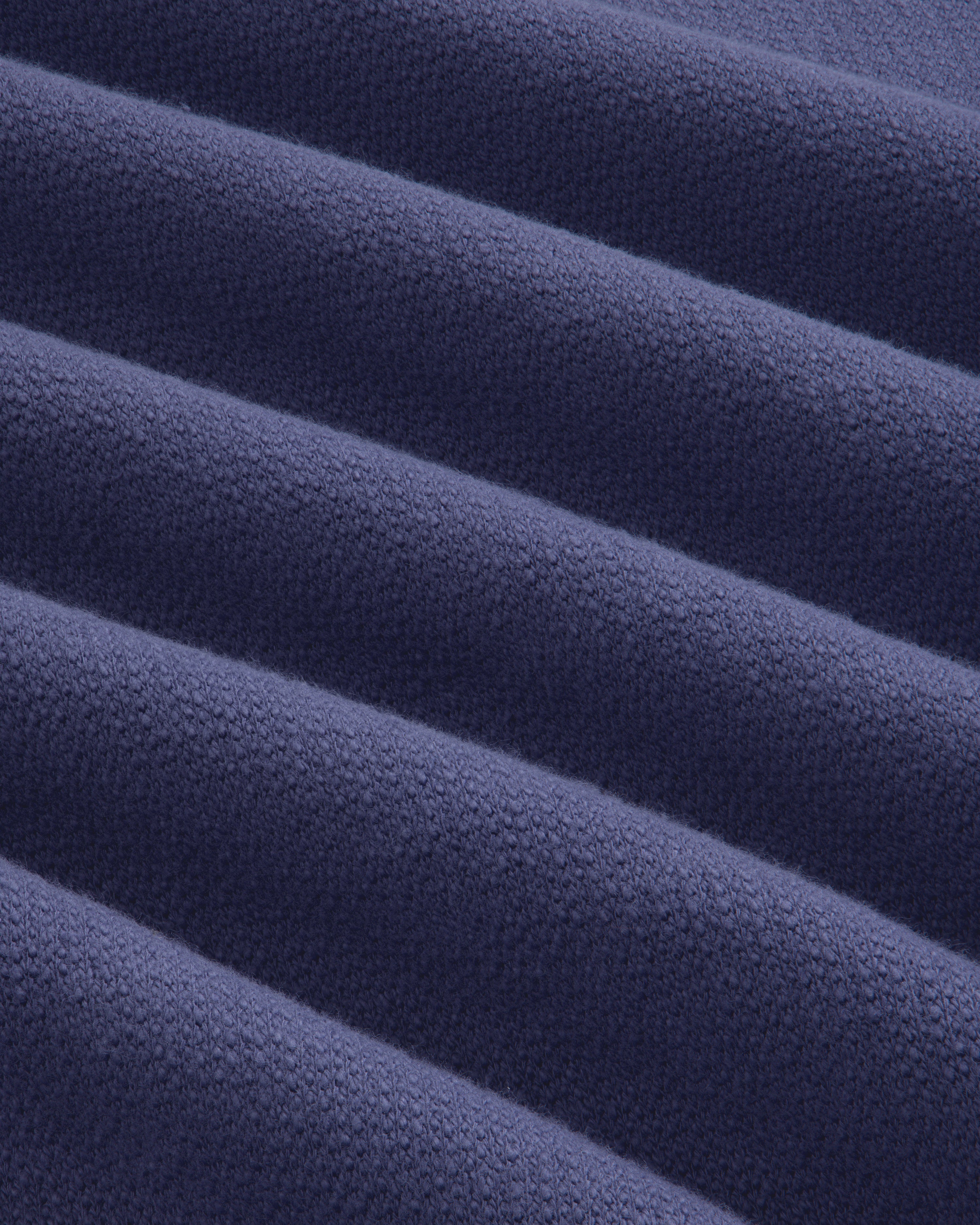 Close-up of soft, ribbed fabric from the Stone Washed Marina Crewneck Sweatshirt in dark blue.