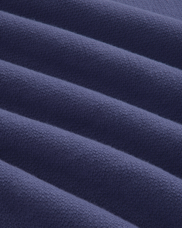 Close-up of soft, ribbed fabric from the Stone Washed Marina Crewneck Sweatshirt in dark blue.