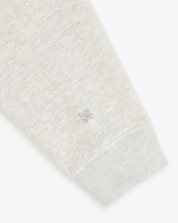 Stone Washed Marina Crewneck Sweatshirt in light gray with ribbed cuff and subtle small embroidered logo near the hem.