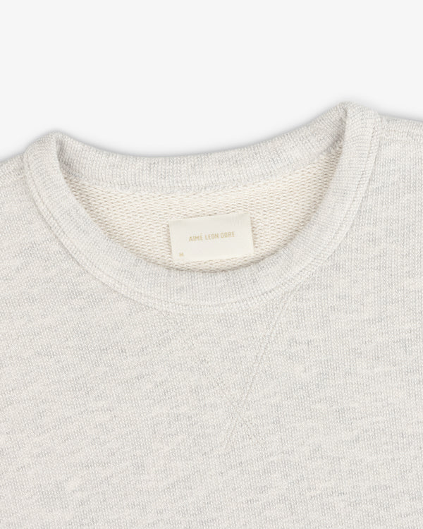 Stone Washed Marina Crewneck Sweatshirt in light gray with visible Aimé Leon Dore label inside collar.