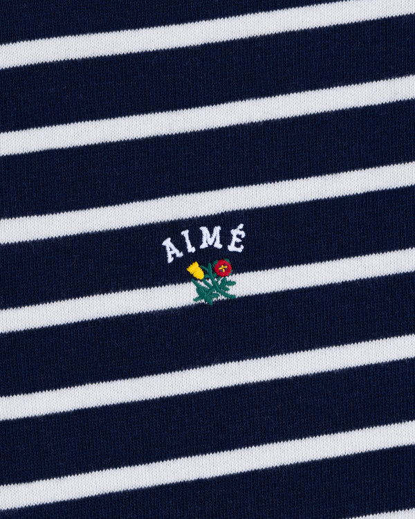 Navy and white Striped Crest Quarter Zip with AIMÉ text and a small yellow/red flower embroidered below.