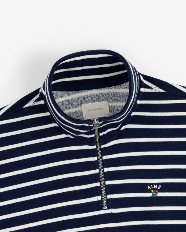 Striped Crest Quarter Zip in navy and white with small AIME logo and flower chest detail.
