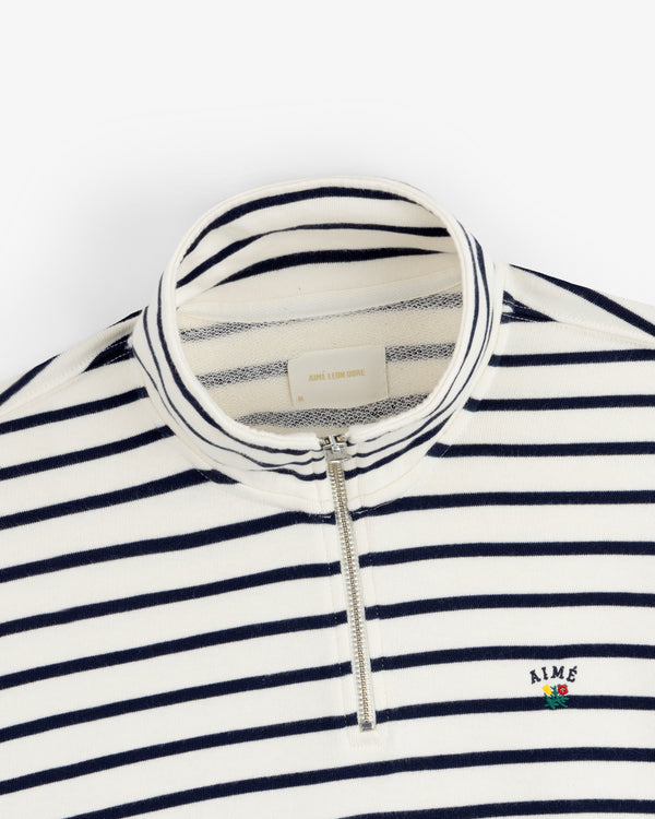 Striped Crest Quarter Zip: Navy/white stripes, AIME embroidery, and a small flower on chest.