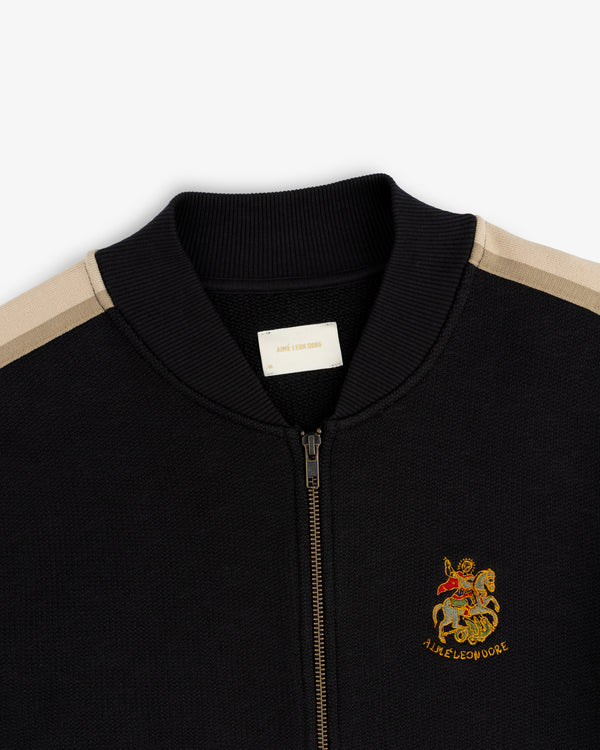 Saint George Track Jacket: Black zip-up with beige stripes, knight & lion crest embroidered on the left chest.