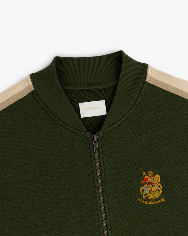 Saint George Track Jacket: Olive green zip-up with beige shoulder stripes and an embroidered chest crest.
