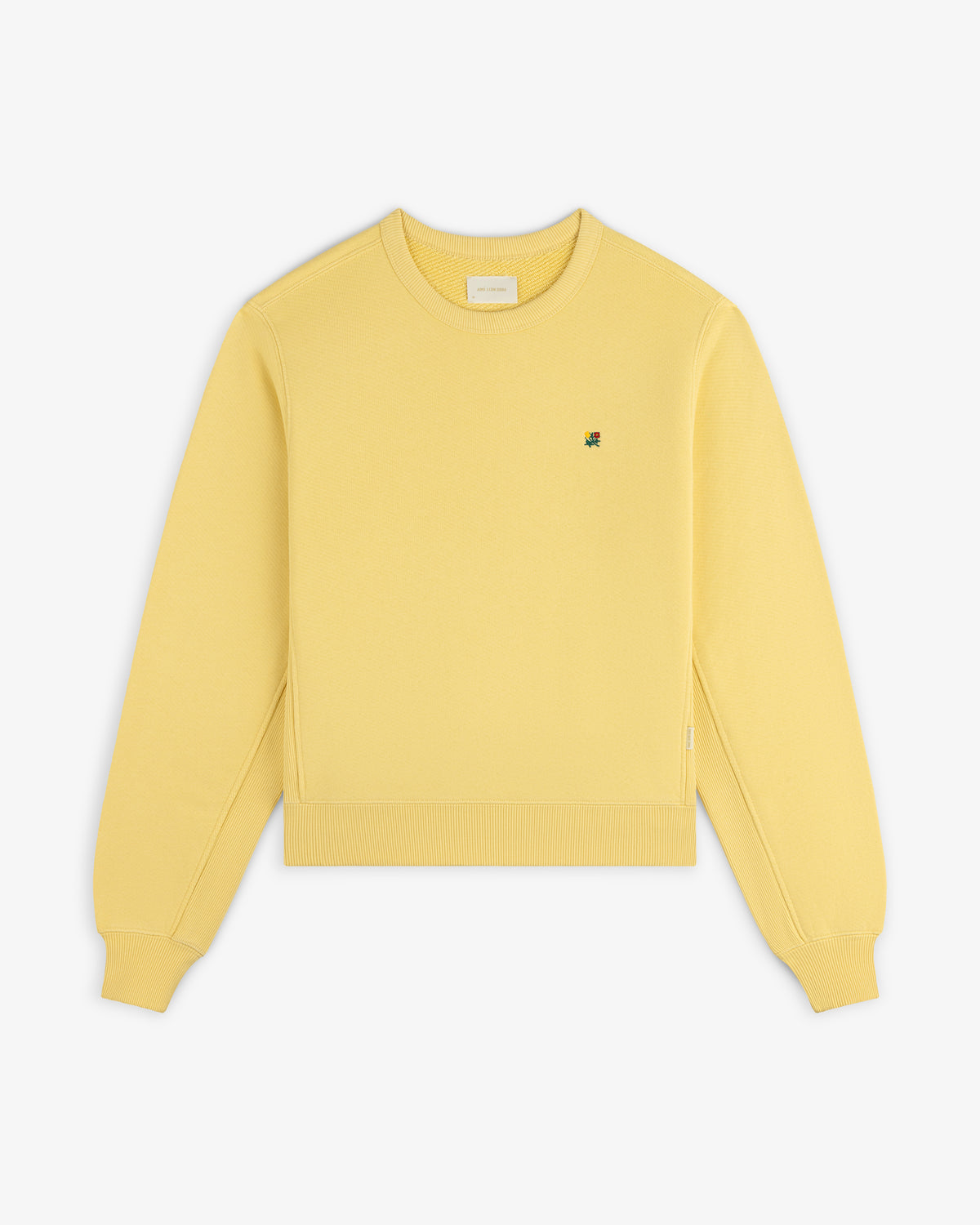Pale yellow Crest Crewneck Sweatshirt with a small floral embroidery on the chest.
