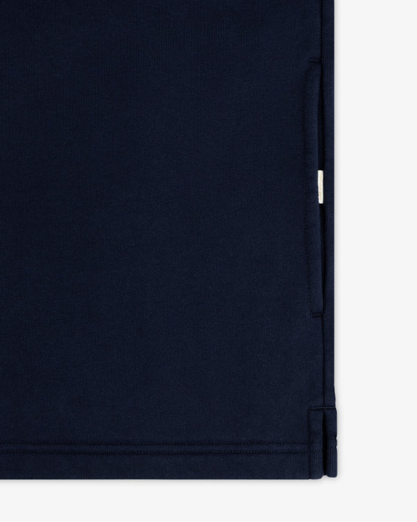 Close-up of the Aimé Souvenir Quarter Zip in navy blue, highlighting the right-side pocket seam.