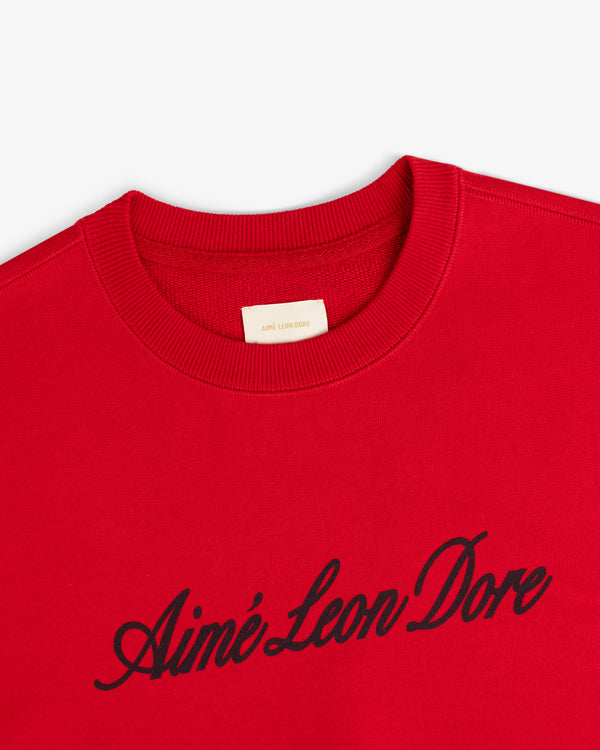 Vintage Script Crewneck Sweatshirt in red with black Aimé Leon Dore script across the chest.